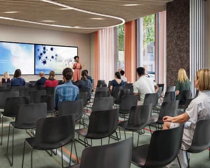 A service person preparing a conference table.