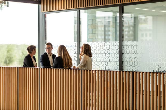 Four people in an office environment